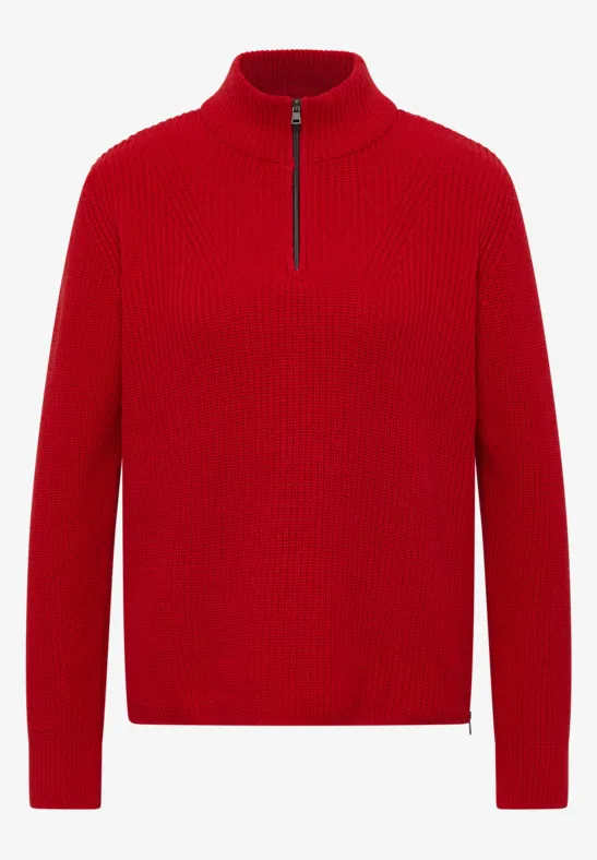 Un pull rouge à col montant, manches longues et fermeture éclair mi-longueur.