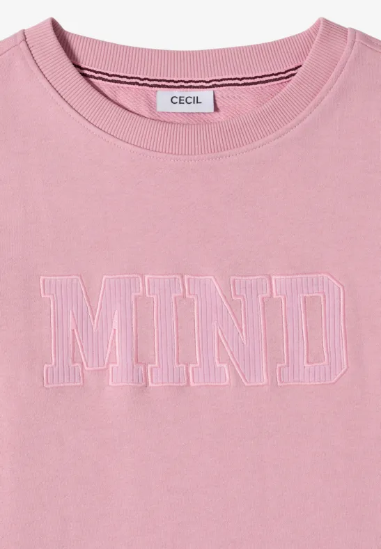 T-shirt rose à col rond avec inscription blanche MIND sur la poitrine.