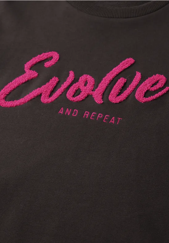 Schwarzes Shirt mit pinkem Schriftzug "Evolve and Repeat"