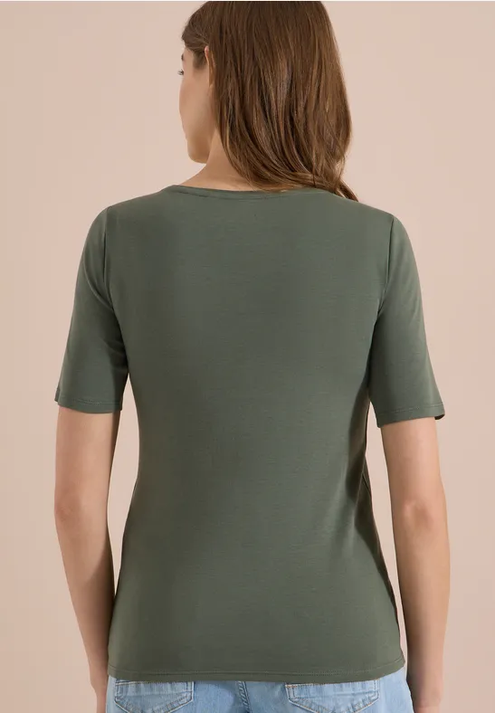 Rückansicht einer Frau in schmal geschnittenem, kurzärmeligem, olivgrünem T-Shirt.