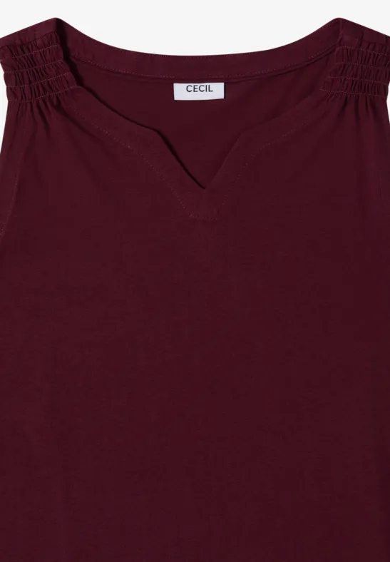 Ärmelloses, bordeauxrotes Top mit V-Ausschnitt und gerafften Schultern.