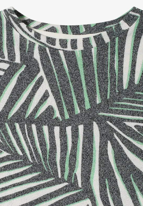 Mouwloze glittertop in zilver met groen palmbladprint.