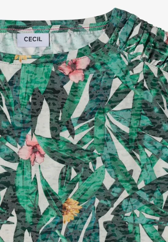 Mouwloos top met groen bladmotief en roze en gele bloemen.