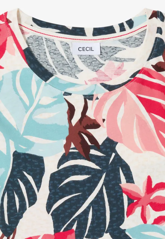 Hellgemusterter Stoff mit bunten tropischen Blättern und Blumen, dazu ein CECIL-Label