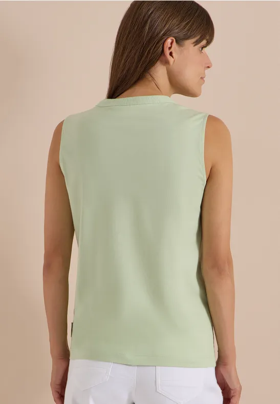 Femme vue de dos portant un débardeur vert menthe.
