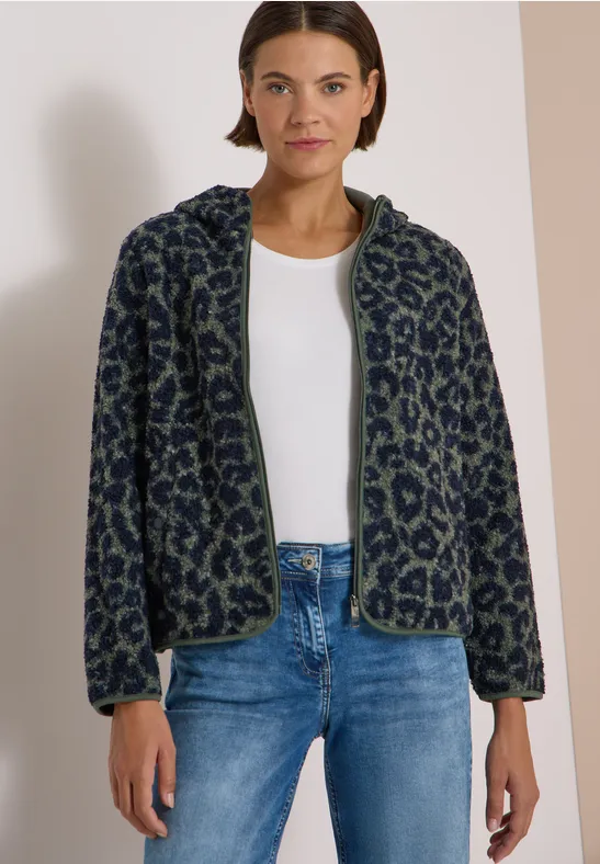 Lockere Fleece-Bomberjacke im Leopardenmuster mit Reißverschluss, passend zu weißem Top und Jeans.