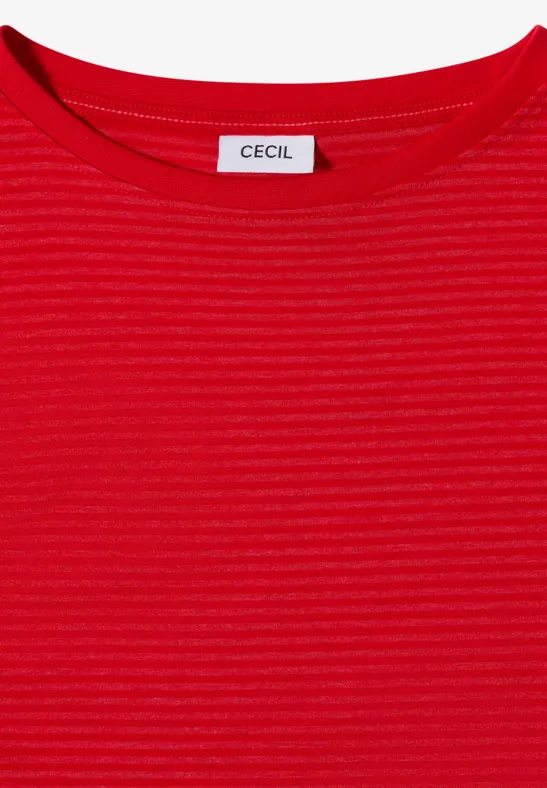 Haut féminin rouge à fines côtes, col rond, étiquette "CECIL" à l’encolure