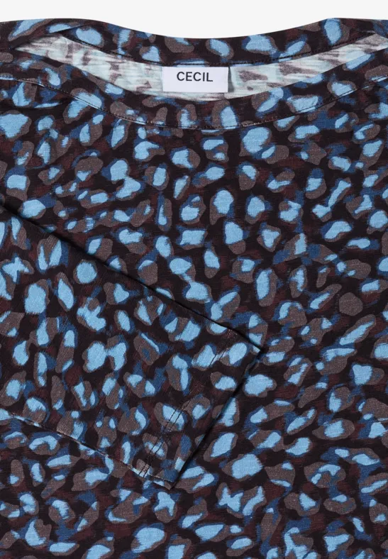 Haut marron à motif de taches bleues et étiquette de marque « CECIL ».