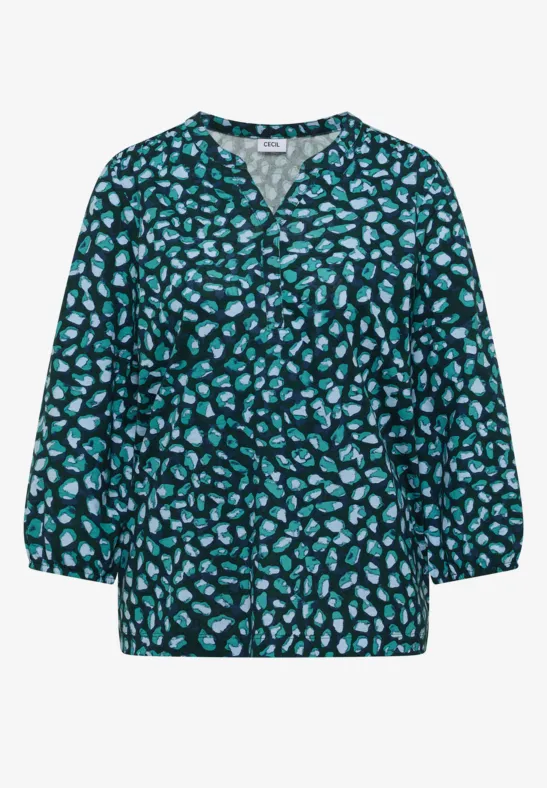 Chemisier vert foncé à coupe ample, col V et motif floral turquoise, manches 3/4.