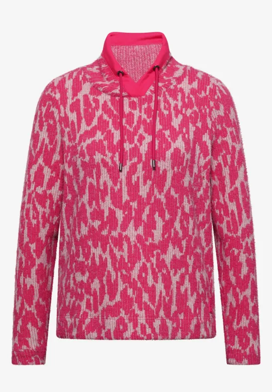 Pink-weißes Langarm-Shirt mit abstraktem Muster und Polokragen.