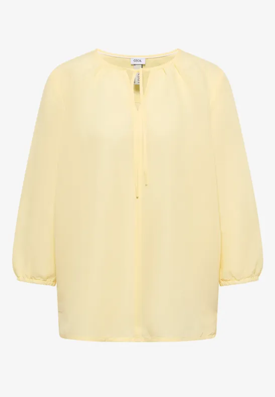 Leichte gelbe Bluse mit 3/4-Ärmeln und gerafftem Rundhalsausschnitt.