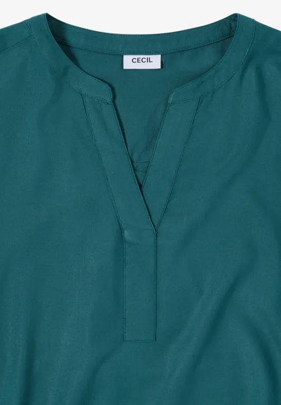 Damesblouse in petrol met V-hals, lange mouwen en 'CECIL'-label.