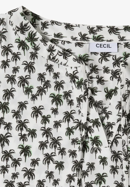 Witte blouse met zwart palmenpatroon en groene accenten.
