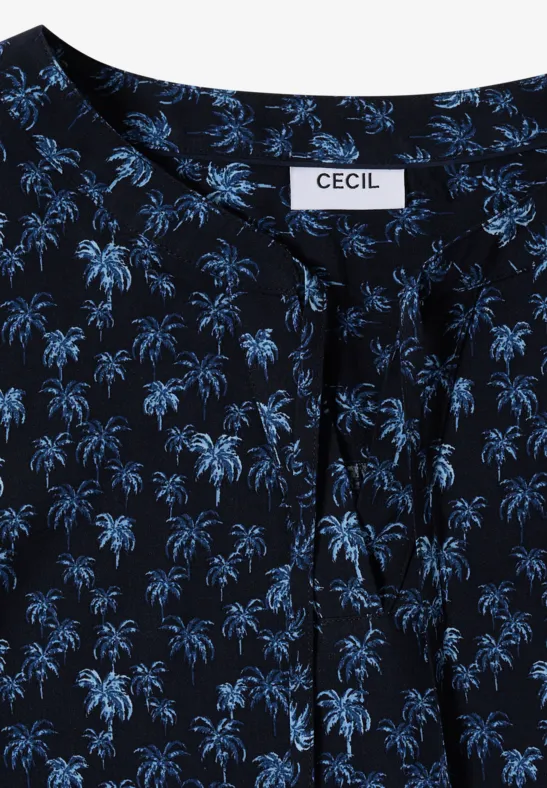 Haut féminin bleu foncé à motif palmiers bleus clairs, encolure nouée, étiquette CECIL.