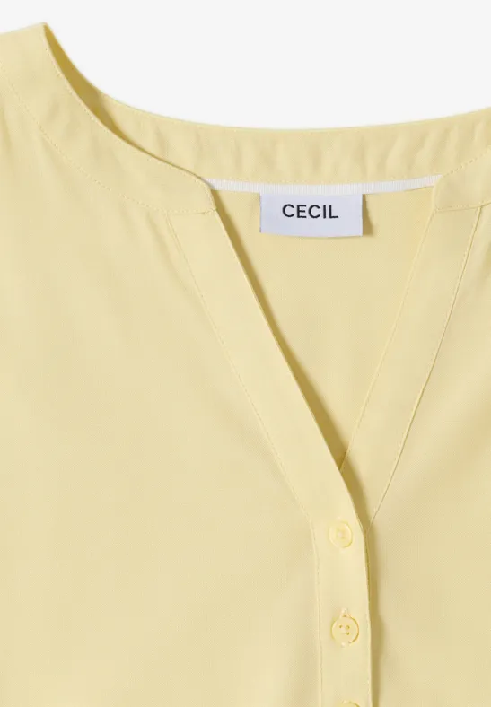Hellgelbe Damenbluse mit V-Ausschnitt und Knopfleiste, Label 'CECIL' sichtbar.