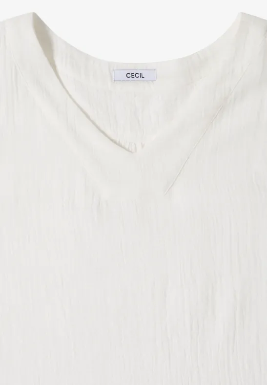 Weißes ärmelloses V-Neck-Top aus leicht strukturierter Baumwolle.
