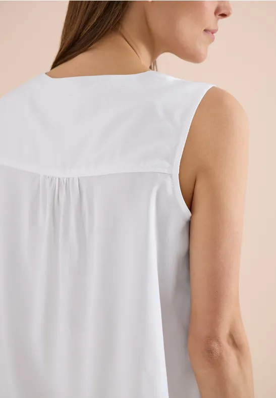 Rückansicht einer Frau in ärmellosem weißen Top