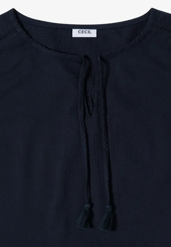 Dunkelblaue Bluse mit Rundhalsausschnitt und Bindebändern mit Quasten.