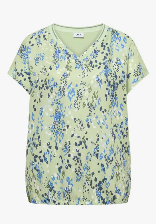 Hellgrüne Bluse mit blauem, abstraktem Blumenmuster, V-Ausschnitt, kurzen Ärmeln und elastischem Saum.