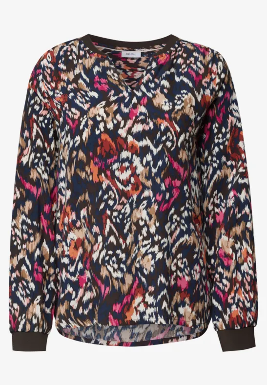 Blouse femme décontractée à manches longues, motif abstrait coloré.