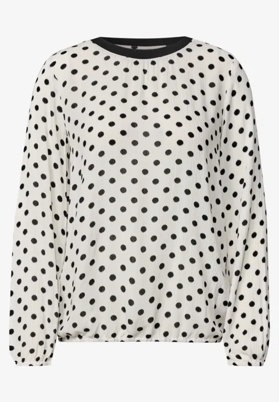 Weißes langärmliges Oberteil mit schwarzem Polka-Dots-Muster