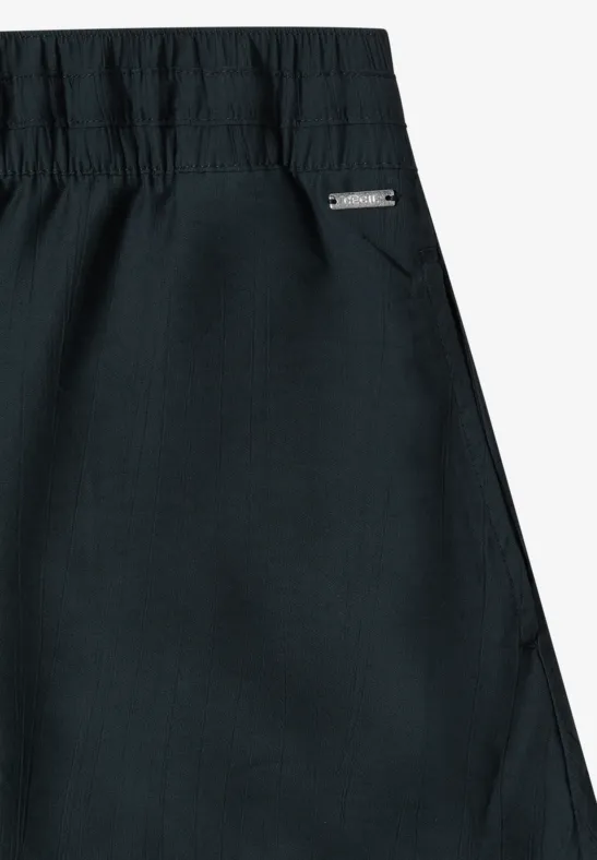 Zwart kledingstuk met elastische taille en zijzak met een klein label.