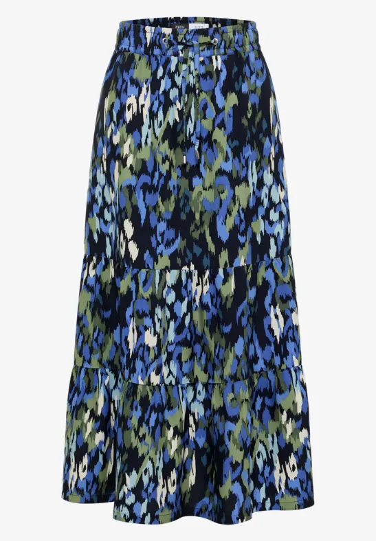 Midirock mit dreistufigem Volant und abstraktem Blumenmuster in Blau, Oliv, Schwarz und Weiß.