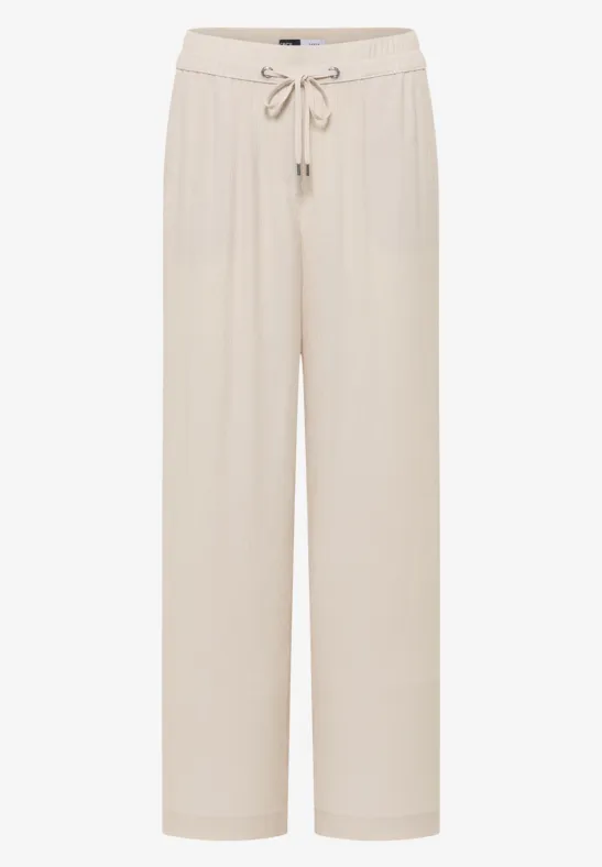 Pantalon ample de loisirs beige clair, taille élastiquée avec cordon de serrage.