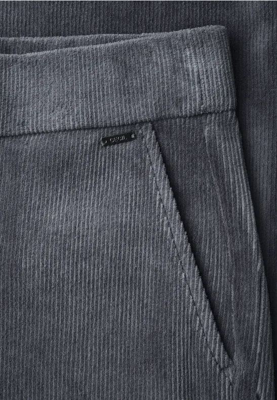 Detailaufnahme einer grauen Cordhose mit Taillenbund und schräger Eingriffstasche.