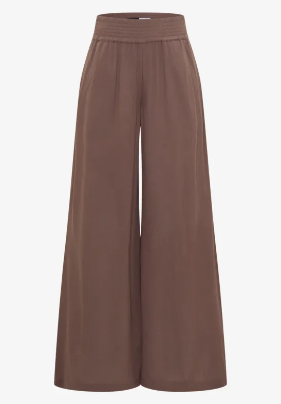 Braune Hose mit weitem Bein, elastischem Bund und fließendem, weichem Stoff.