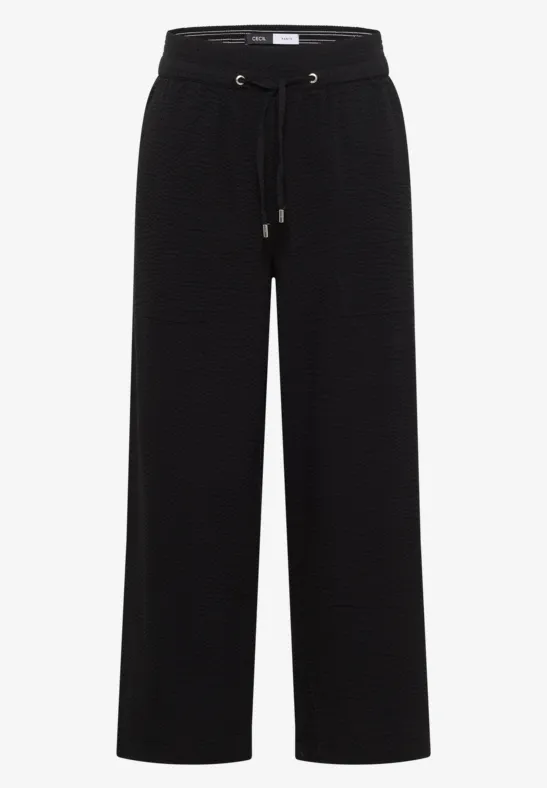 Schwarze, weite Stoffhose mit hohem Bund und Kordelzug.