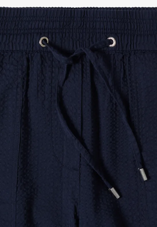 Donkerblauwe sweatpants met elastische taille, aantrekkoord en gestructureerde tricotstof.