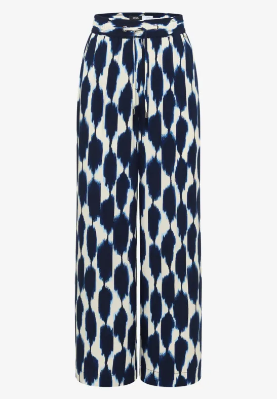Locker geschnittene, blau-weiße Palazzo-Hose mit abstraktem Muster und hohem Bund.