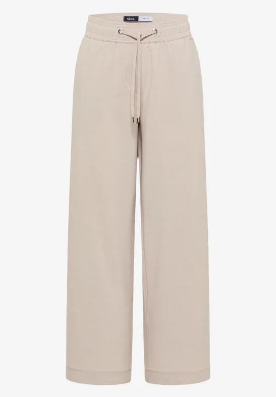 Beige, wijde joggingbroek met losse pasvorm en koordsluiting in de taille.