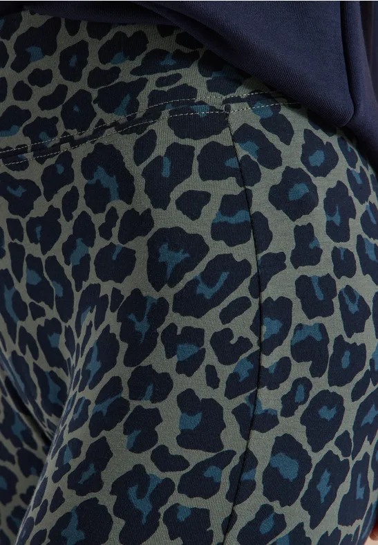 Close-up van een broek met blauw-zwart luipaardprint.