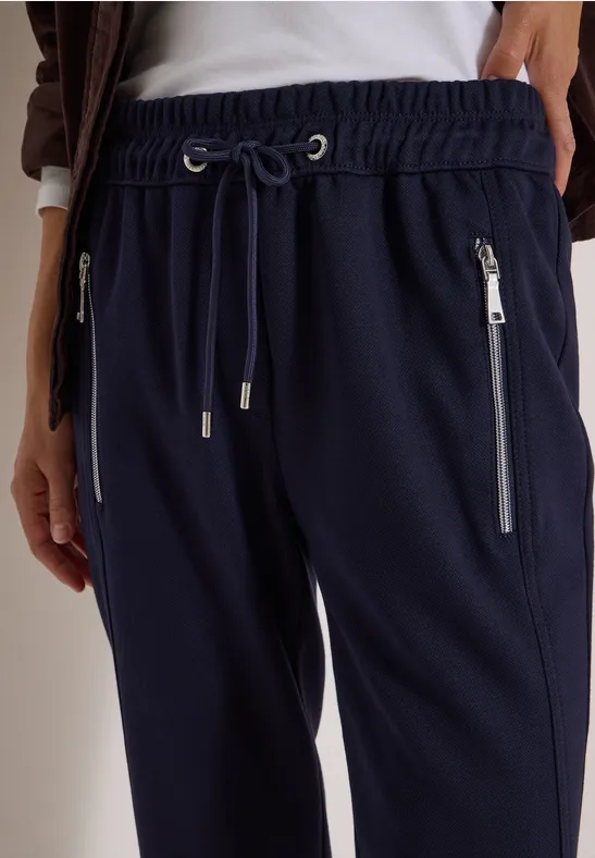 Dunkelblaue Jogginghose mit elastischem Bund, Kordelzug und seitlichen Reißverschlusstaschen.