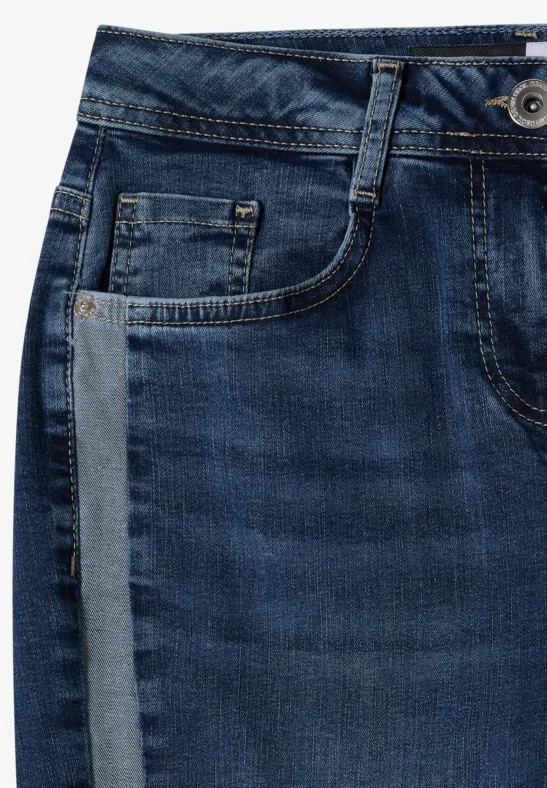 Gros plan d'un jean bleu avec passants de ceinture, poche avant et bouton visible.