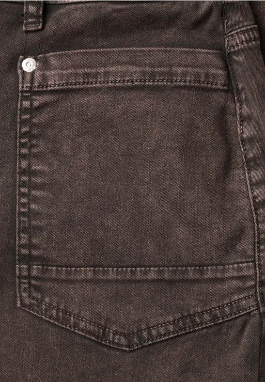 Nahaufnahme einer dunkelbraunen Jeanshintertasche mit Nahtdetails.