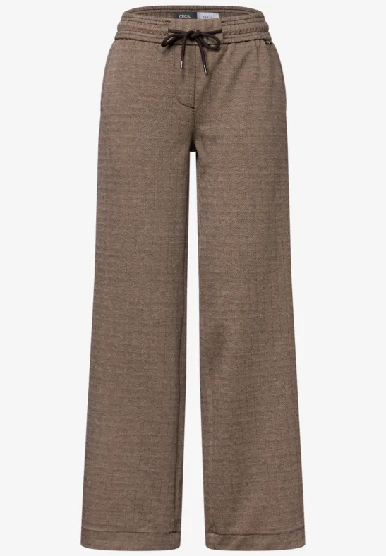 Braune, gemusterte, weite Damenhose mit Kordelzugbund.