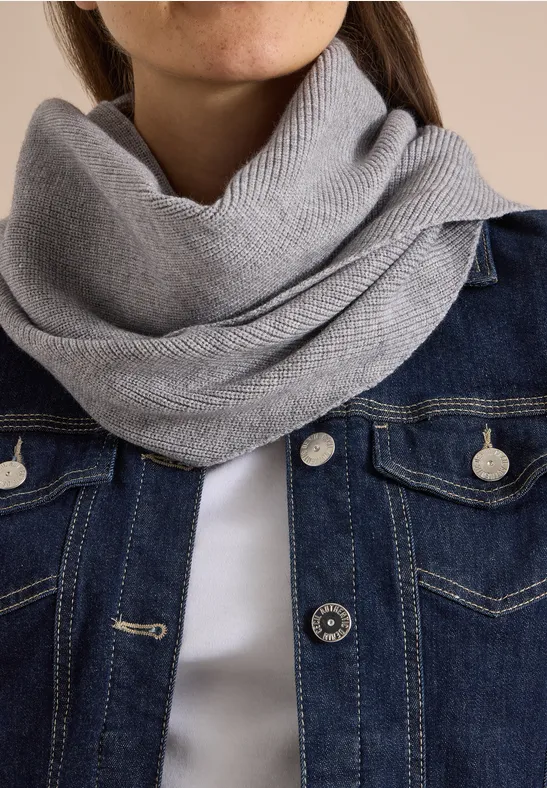 Gros plan sur un snood gris et une veste en jean, centré sur le cou et le torse.