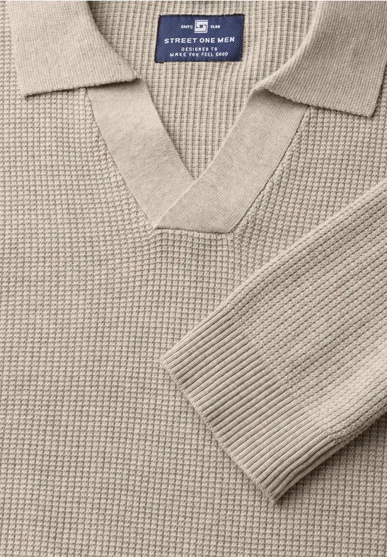Beiger Strickpullover mit Kragen und V-Ausschnitt, Detailaufnahme.