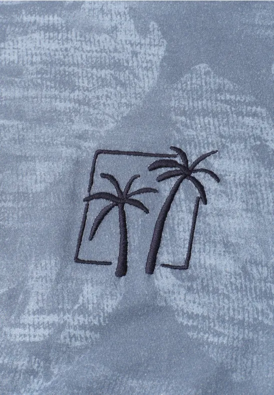 Zwei stilisierte Palmen als schwarze Stickerei auf grauem, texturiertem Stoff