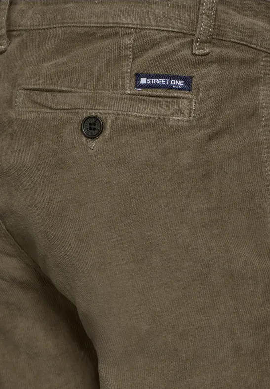 Gros plan sur un pantalon en velours côtelé marron avec étiquette.