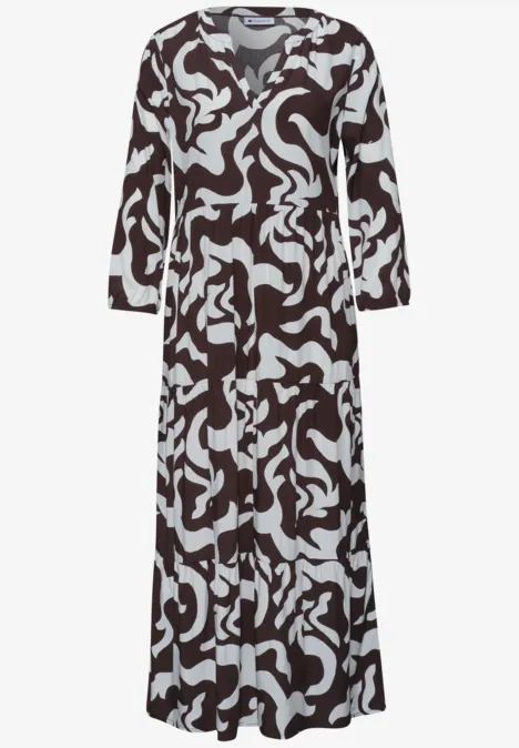 Langärmliges Maxikleid mit schwarzem und weißem abstraktem Muster und V-Ausschnitt.