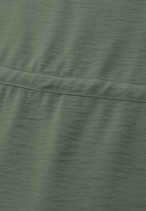 Tissu vert olive avec couture et texture subtile.