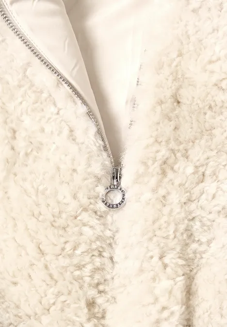 Weißer Teddy-Fleece-Reißverschluss mit silbernem Ringanhänger an weichem, flauschigem Stoff.