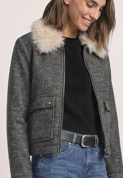 Overshirt mit Woll-Anteil und Fake-Fur-Kragen Obsidian Blue Frau lächelt in grauer Jacke mit Pelzkragen, schwarzem Pullover, Jeans und Gürtel.
