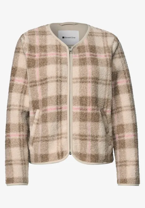 Veste beige à carreaux pour femme, col rond, fermeture éclair et poches plaquées.