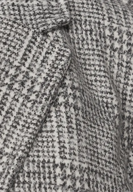 Blazer mit Karomuster und Knöpfen Black Nahaufnahme eines schwarz-weißen Hahnentrittmusters auf Wollstoff.