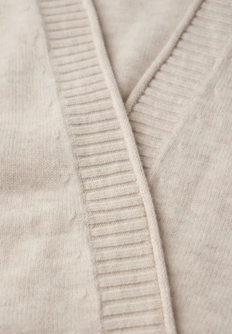 Cardigan avec bord roulé tusk cream mel.